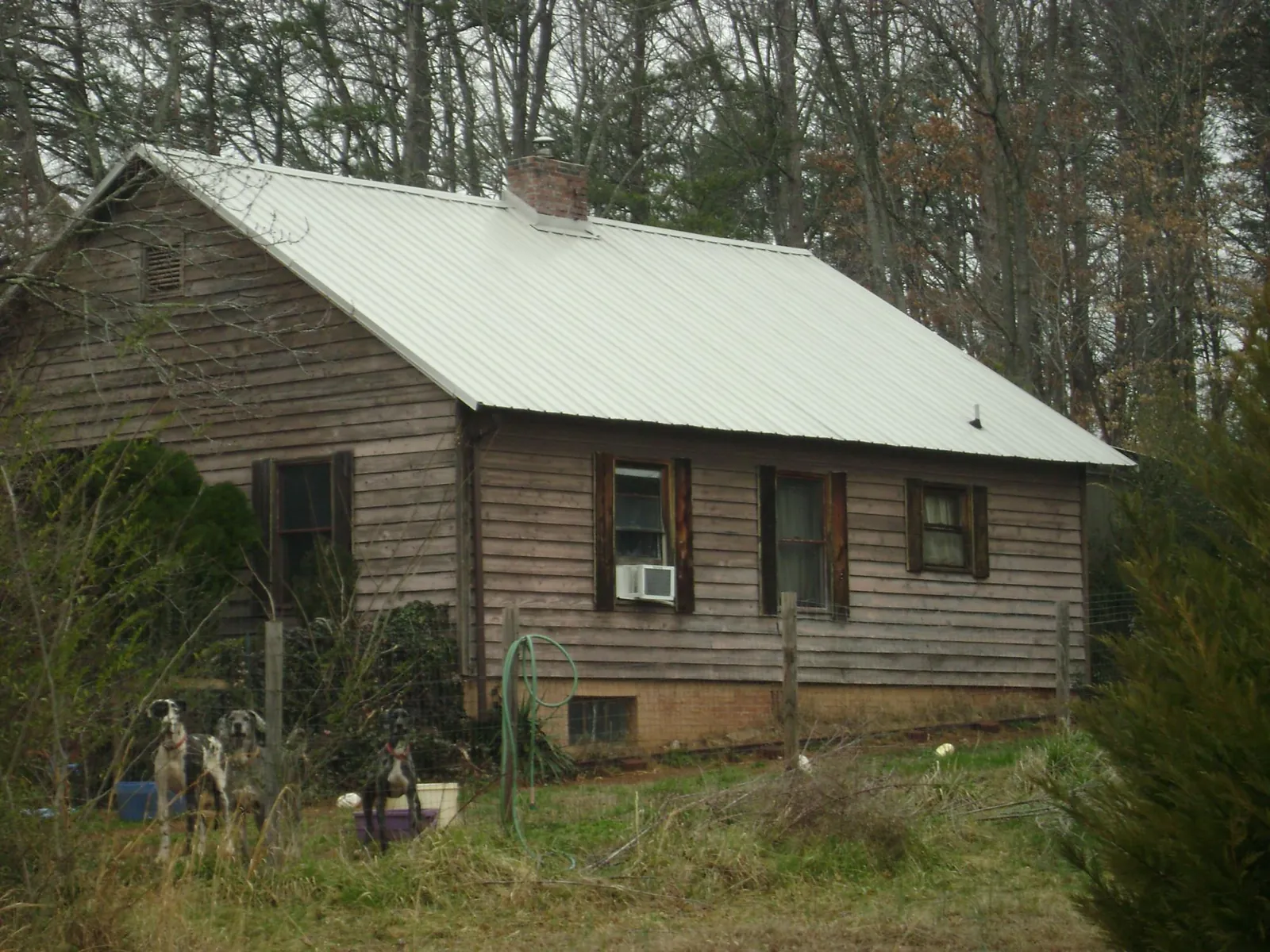 White metal roof on an old wood sided farmhouse, from a Metal Roof Installation job in Turney
